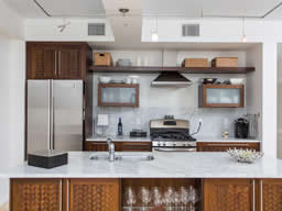 Notice the Carrara marble counter tops and cherry cabinetry.