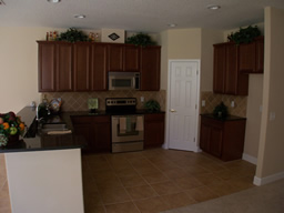 The spacious kitchen has black countertops and a closet pantry.