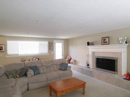 The family room focuses on the fireplace.