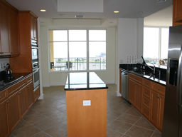 The island kitchen has granite counter tops.